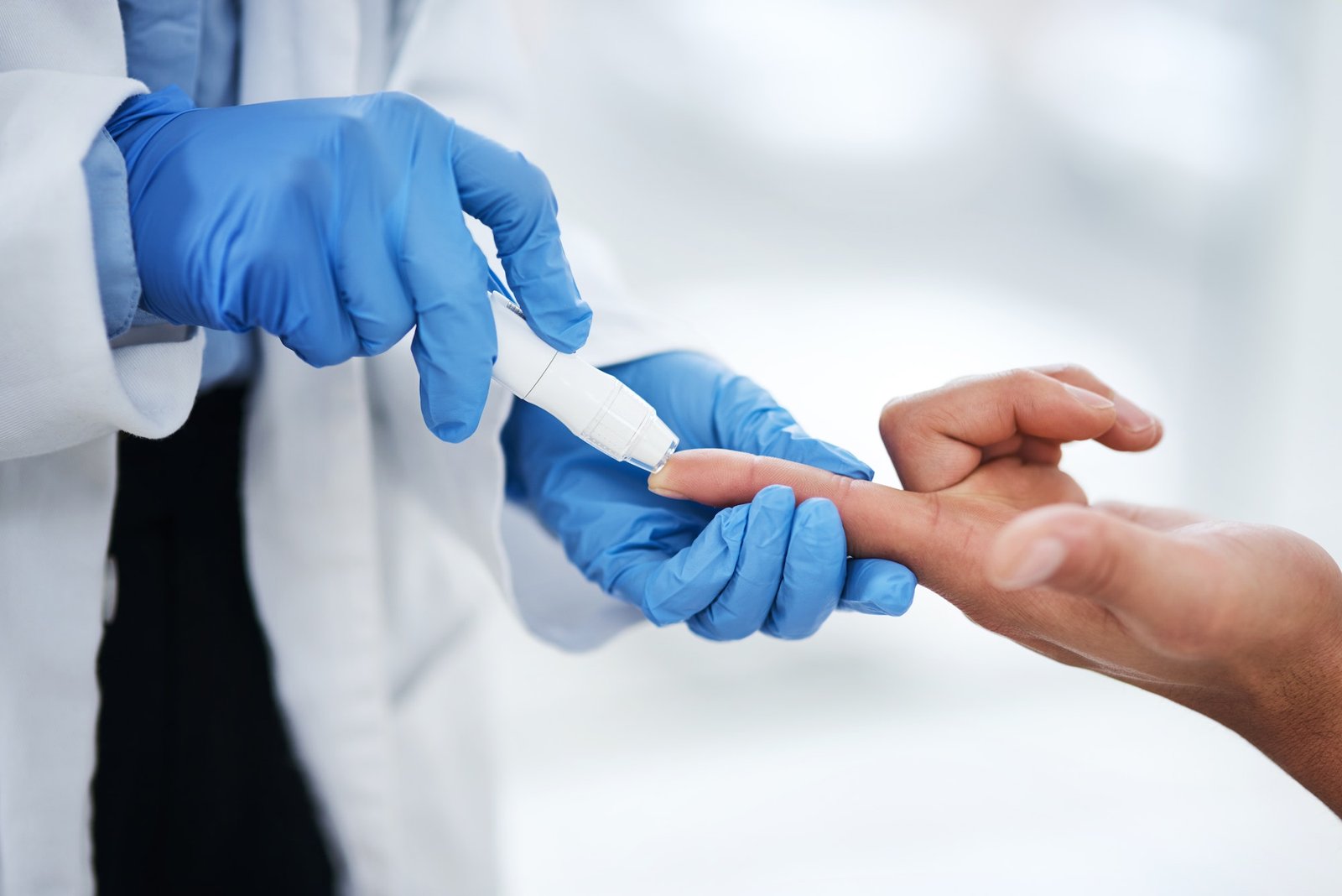 shot-of-an-unrecognisable-doctor-using-a-blood-sugar-test-on-his-patients-finger.jpg